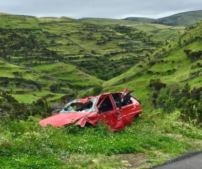 Person comparing low cost car insurance quotes on laptop