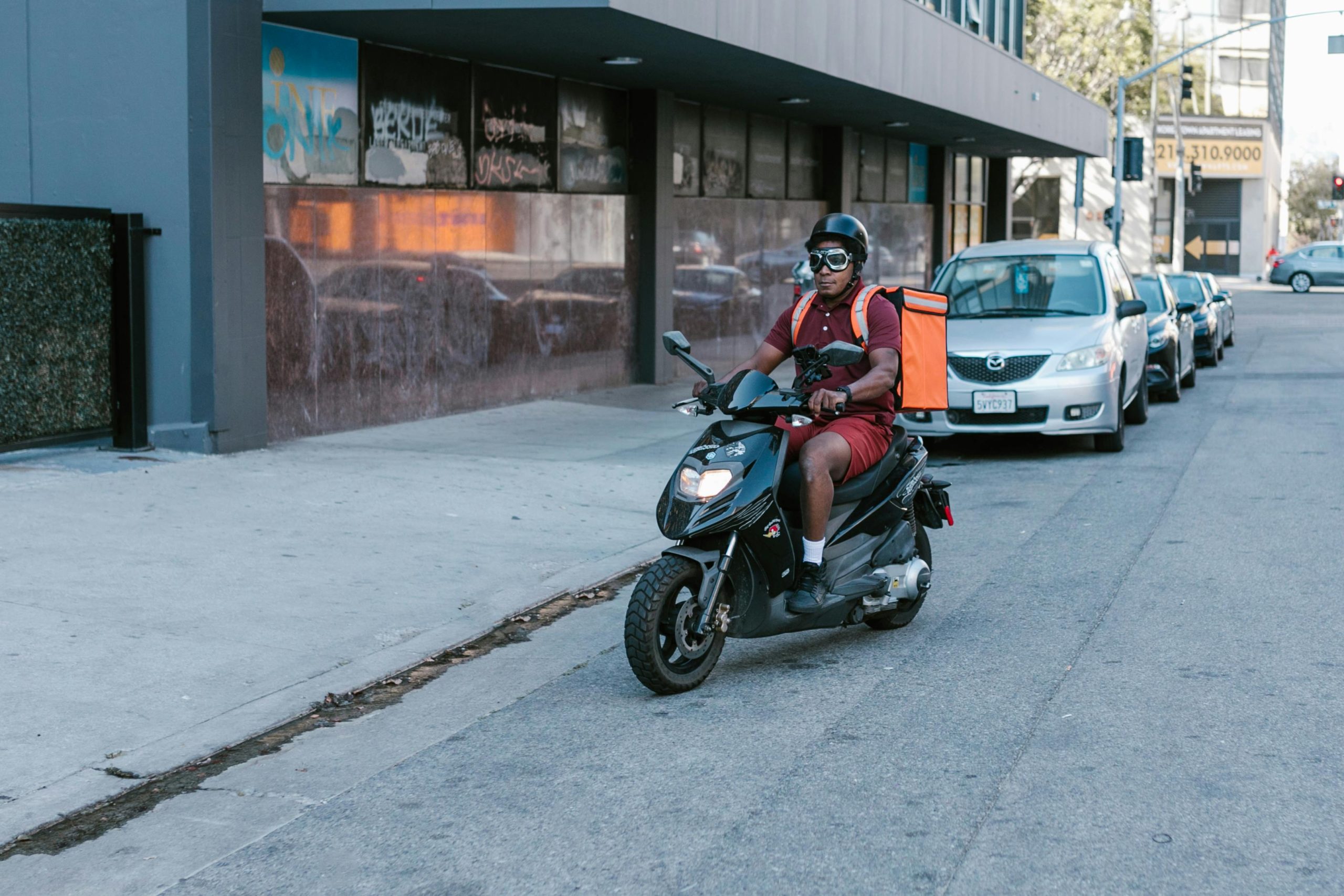 Motorbike courier delivering parcels with insurance cover